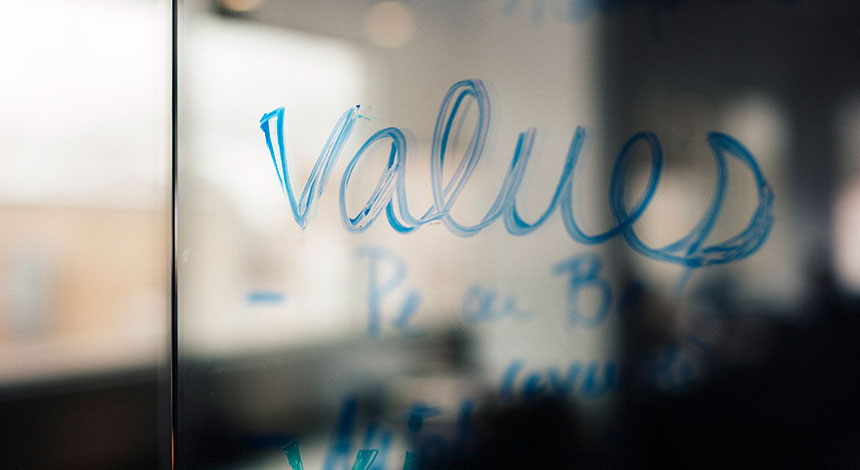 The word 'values' written on a glass wall