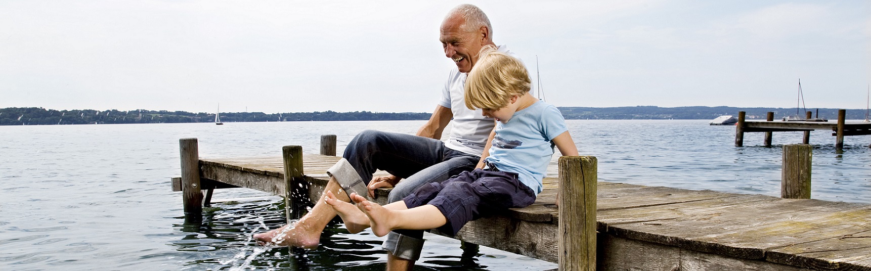 Grandfather and child on a pier
