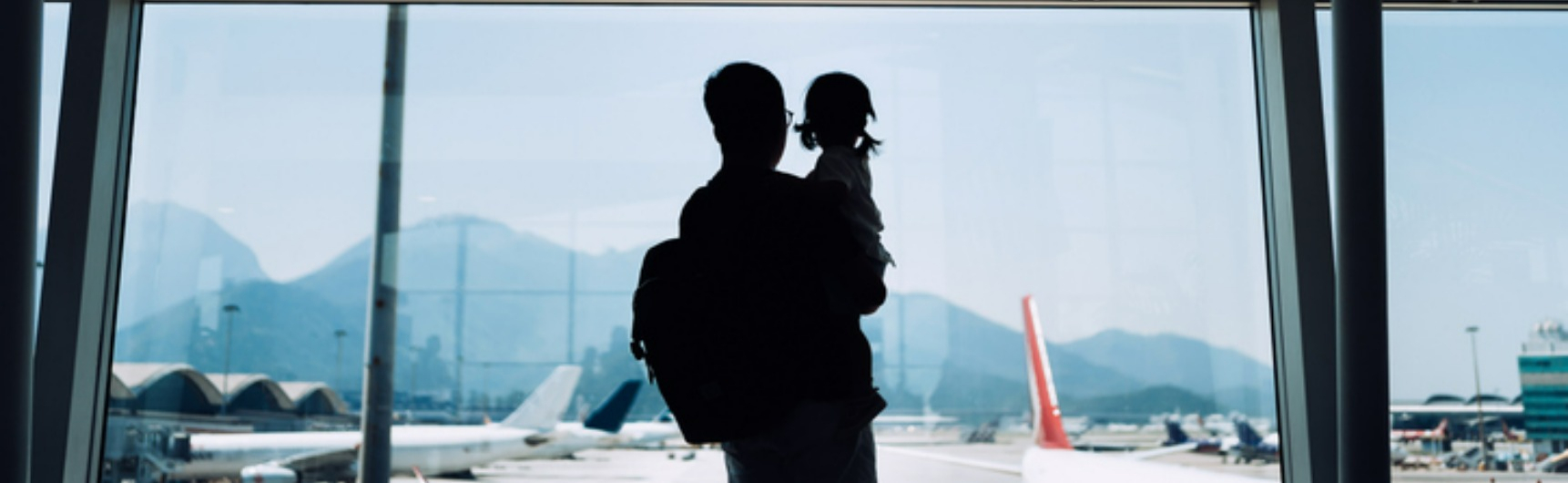 herotravel A man and child look at planes in the airport