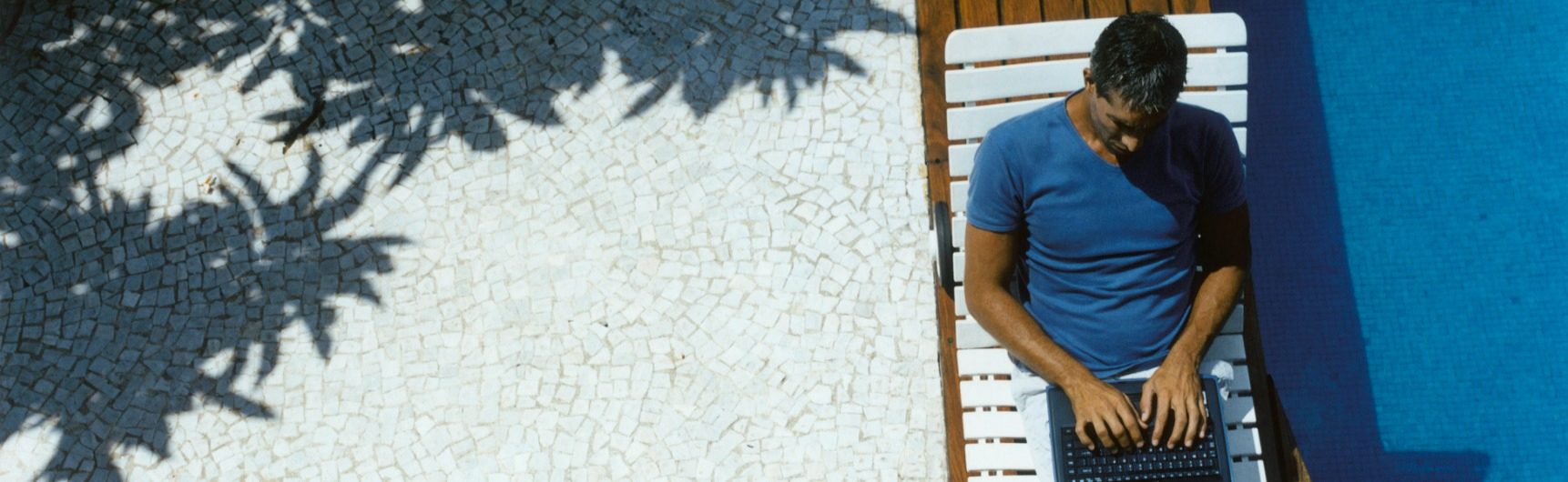 a man works by the pool