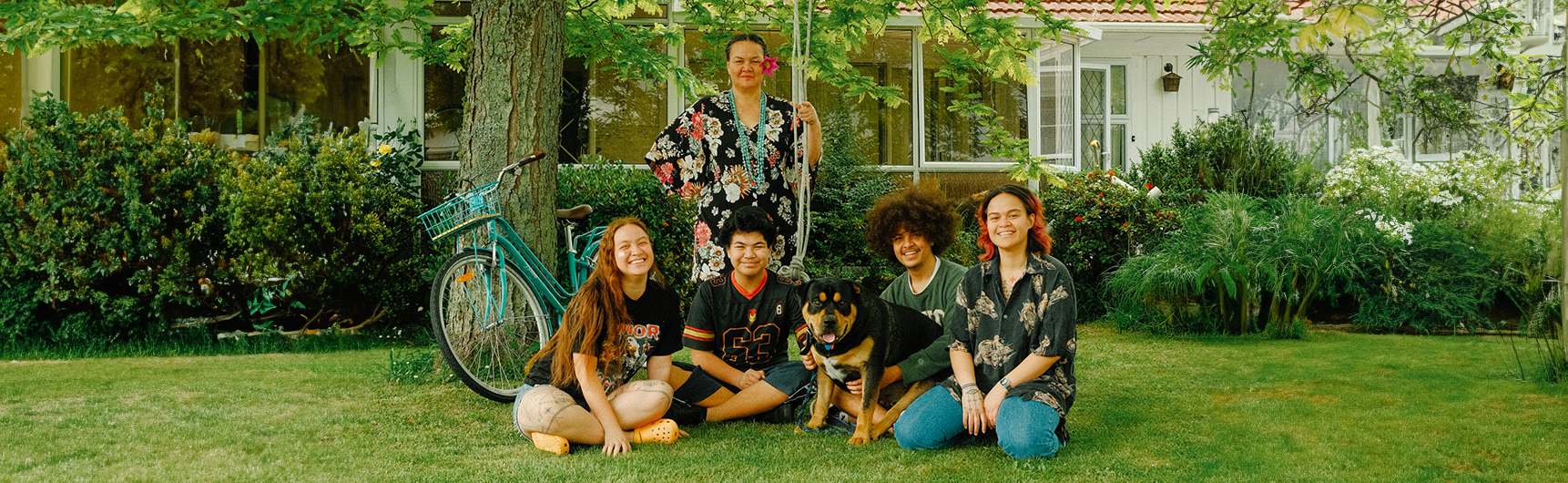 Family sitting under tree