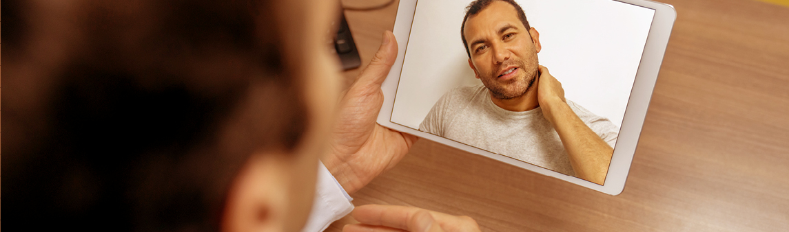 A doctor provides an online consultation via a tablet computer