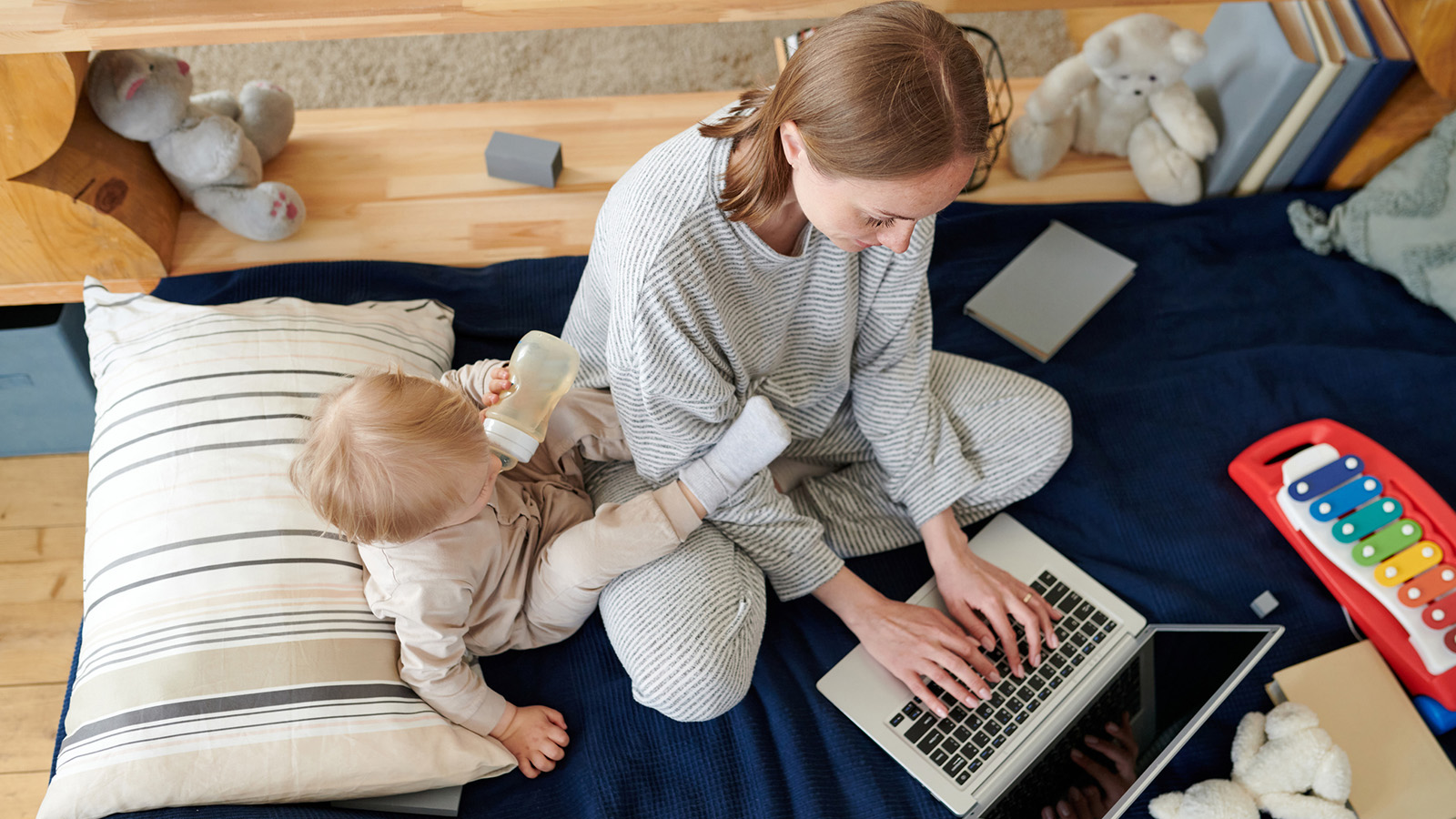 Mother on laptop with baby