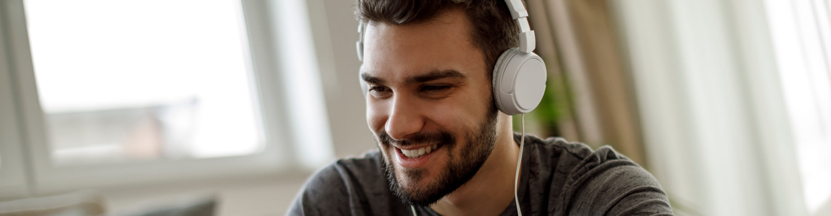 Southern Cross - A man smiles with headphones on A man smiles with headphones on
