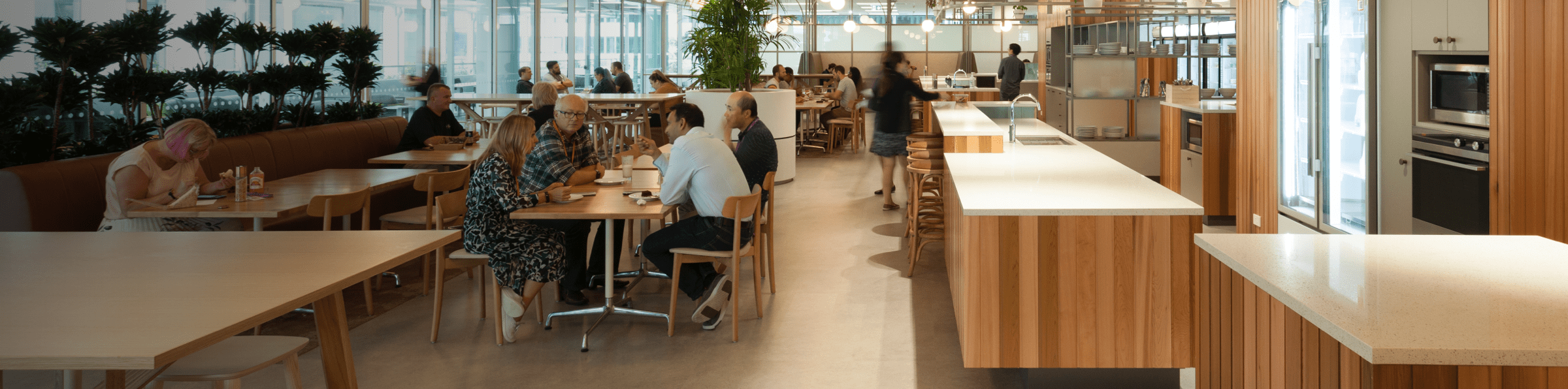 Employees in a large office shared kitchen