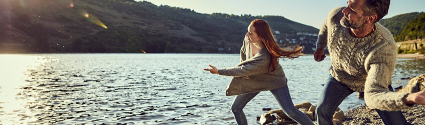 Southern Cross Health Insurance - Cancer Assist banner A man and woman skimming stones on a lake